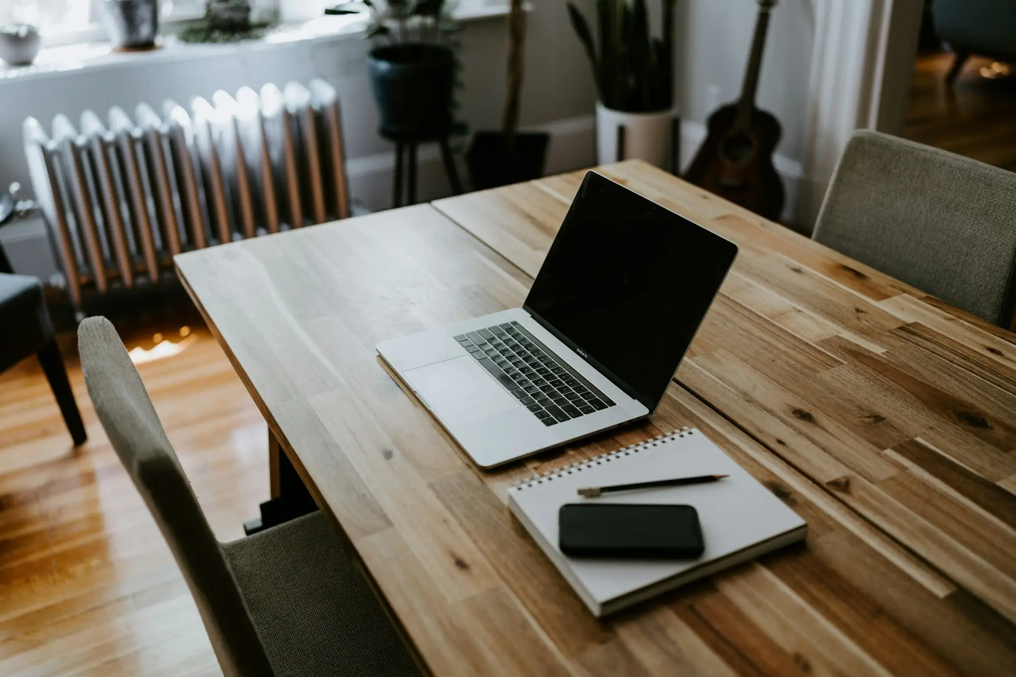 Laptop, calculator and phone on a home office desk