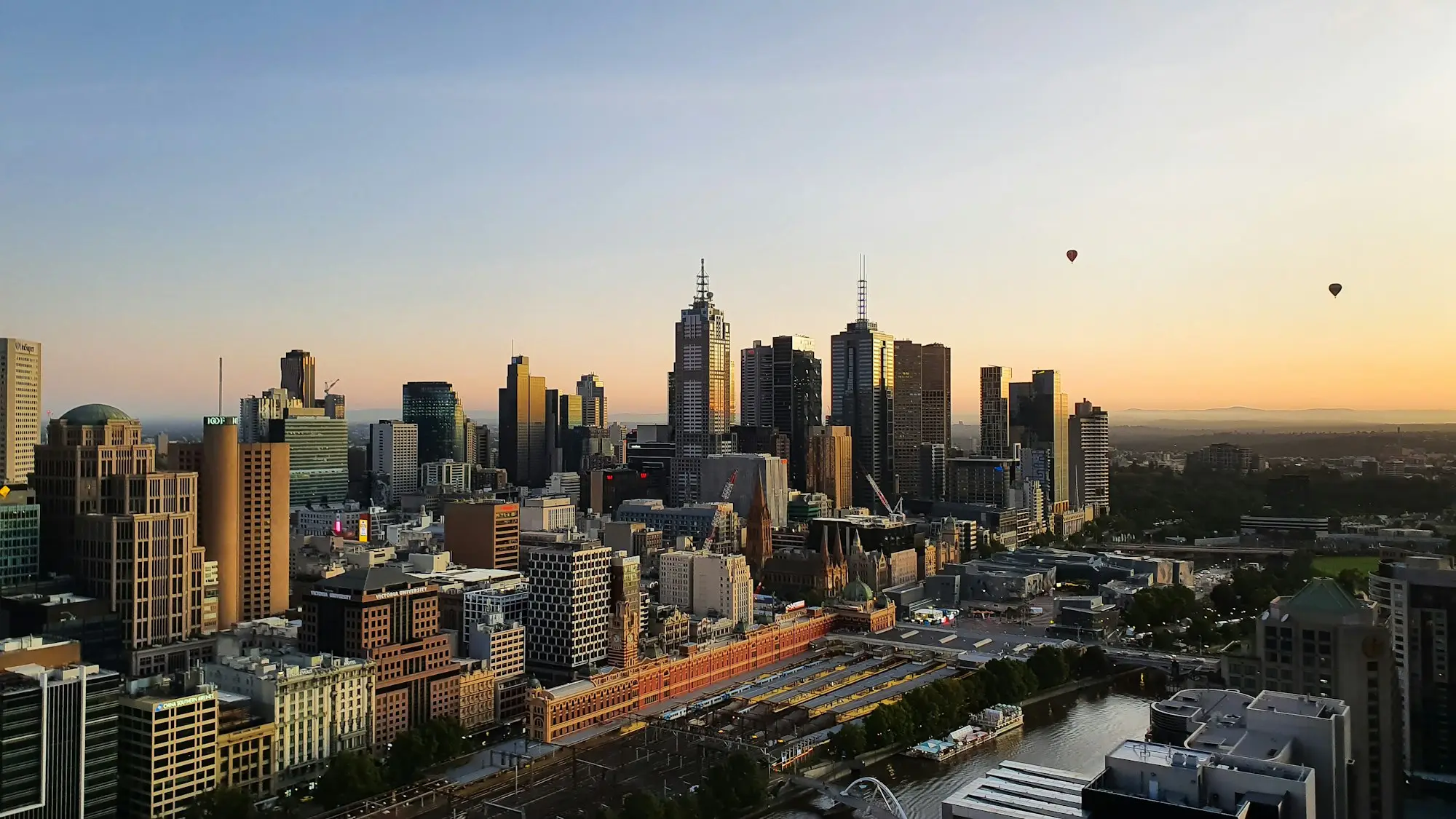 Melbourne city skyline at sunset over inner-city industrial buildings